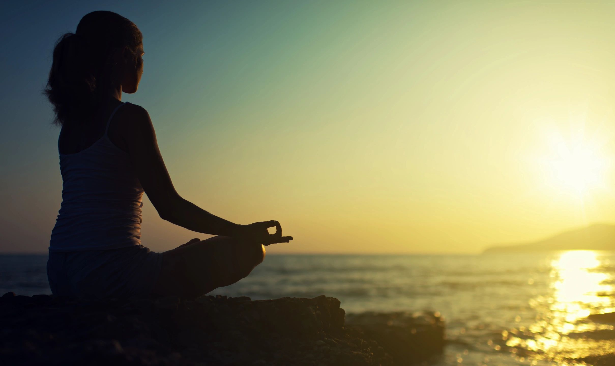 Meditating silhouette at sunset — representing inner peace and mindset transformation